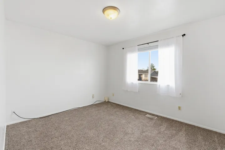 Bedroom with carpet flooring and baseboards
