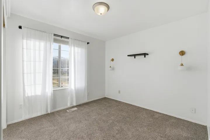 Empty room featuring carpet floors and baseboards