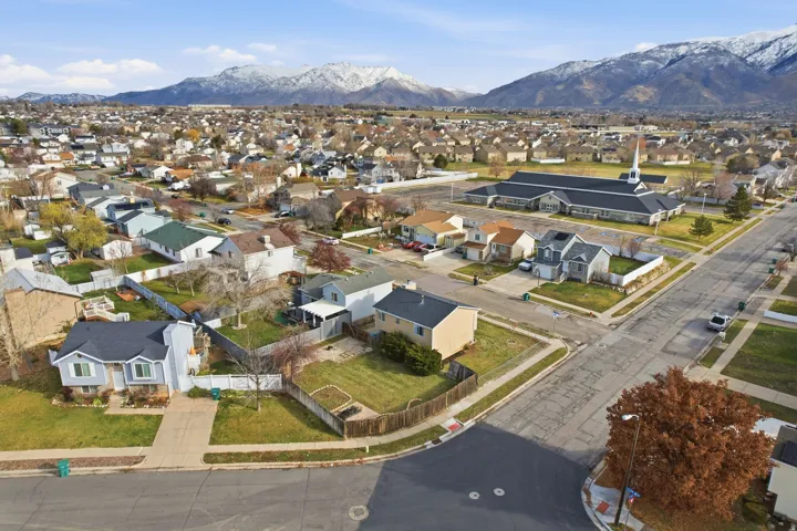 Aerial view of residential area featuring a mountainous background