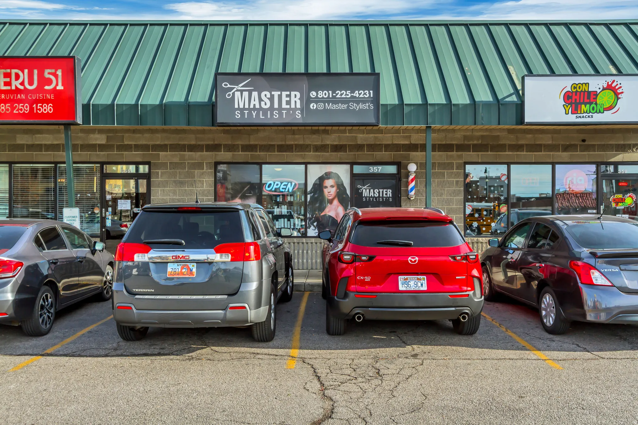 View of commercial property featuring uncovered parking