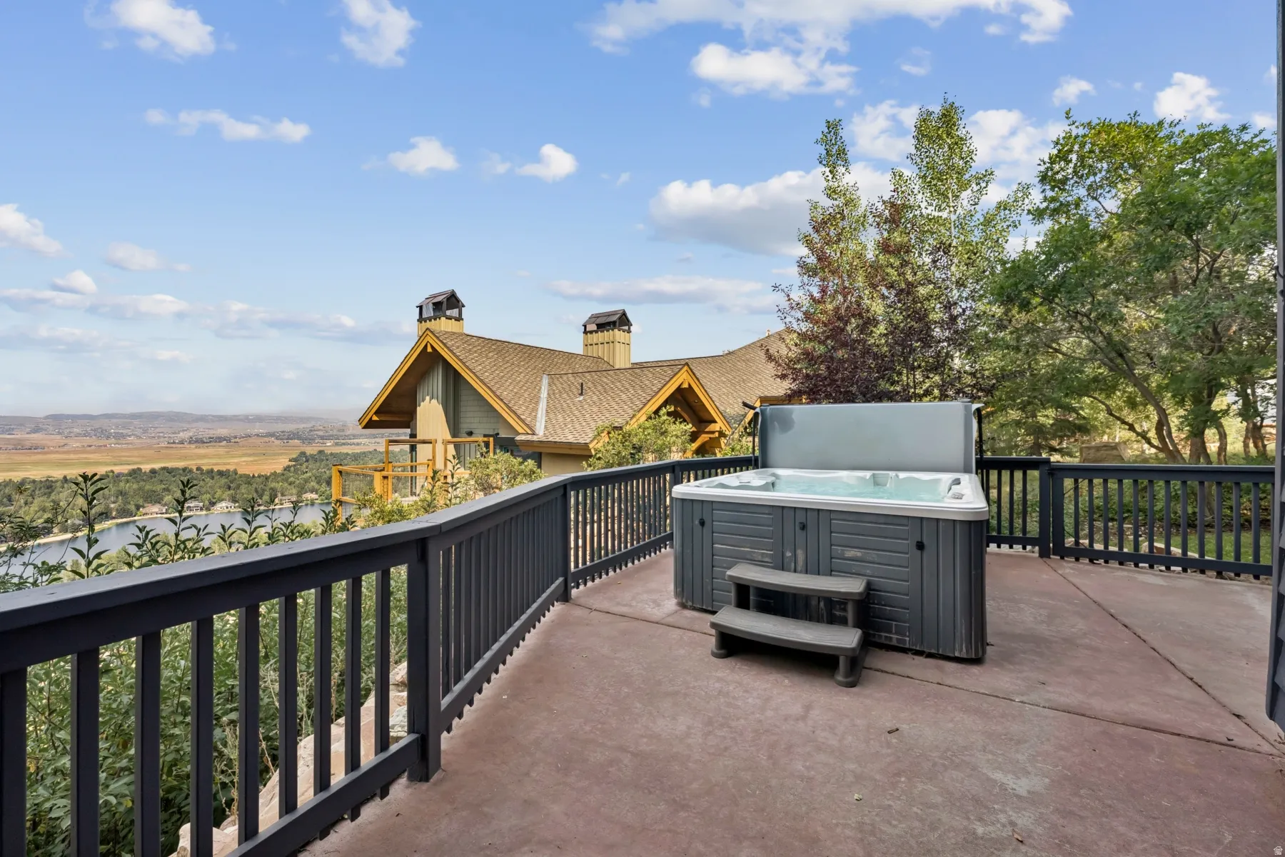 View of patio with a hot tub