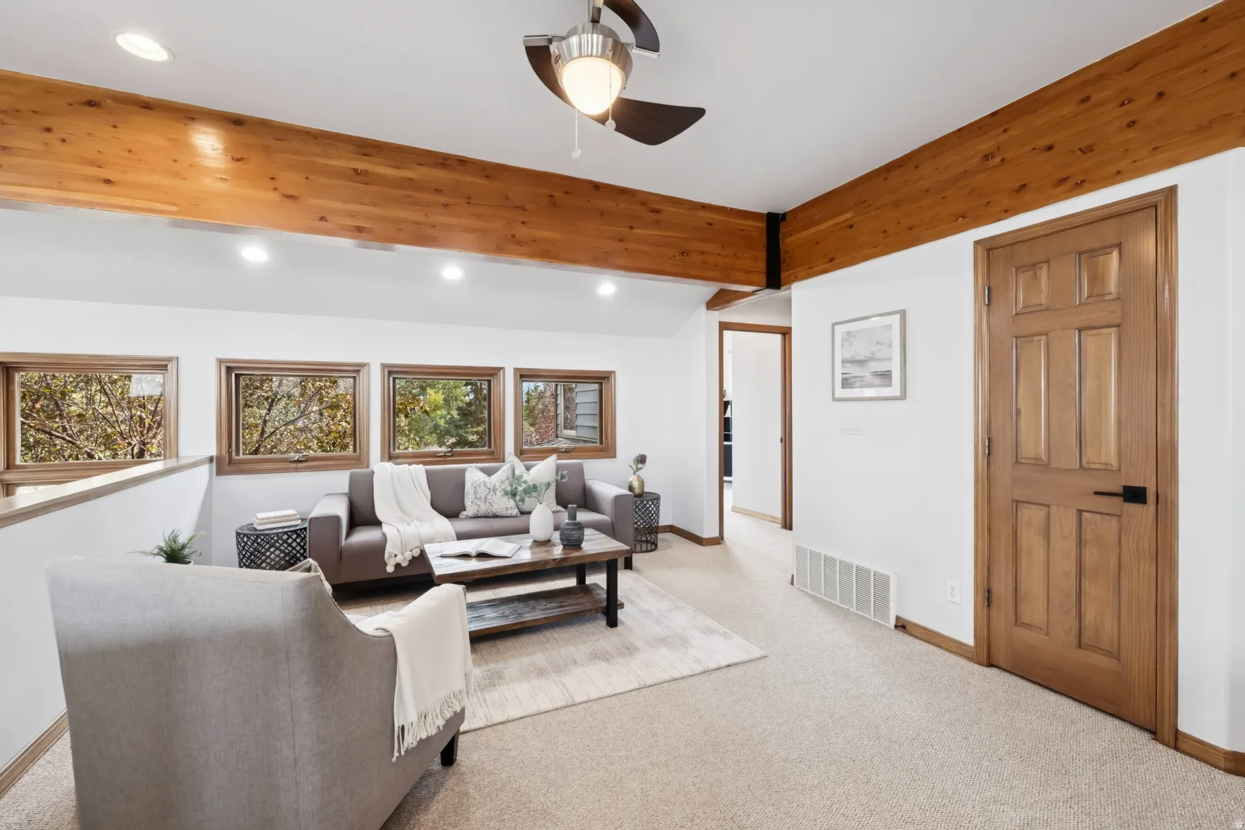 Living area with recessed lighting, light colored carpet, and ceiling fan