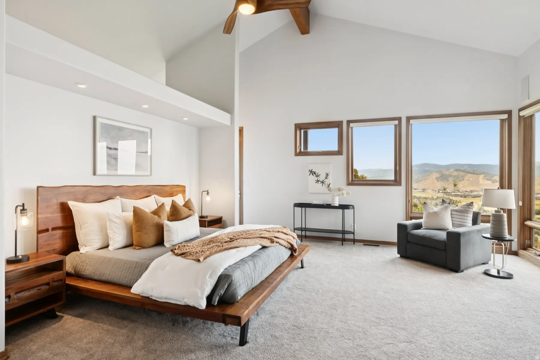 Carpeted bedroom featuring high vaulted ceiling, ceiling fan, and beam ceiling