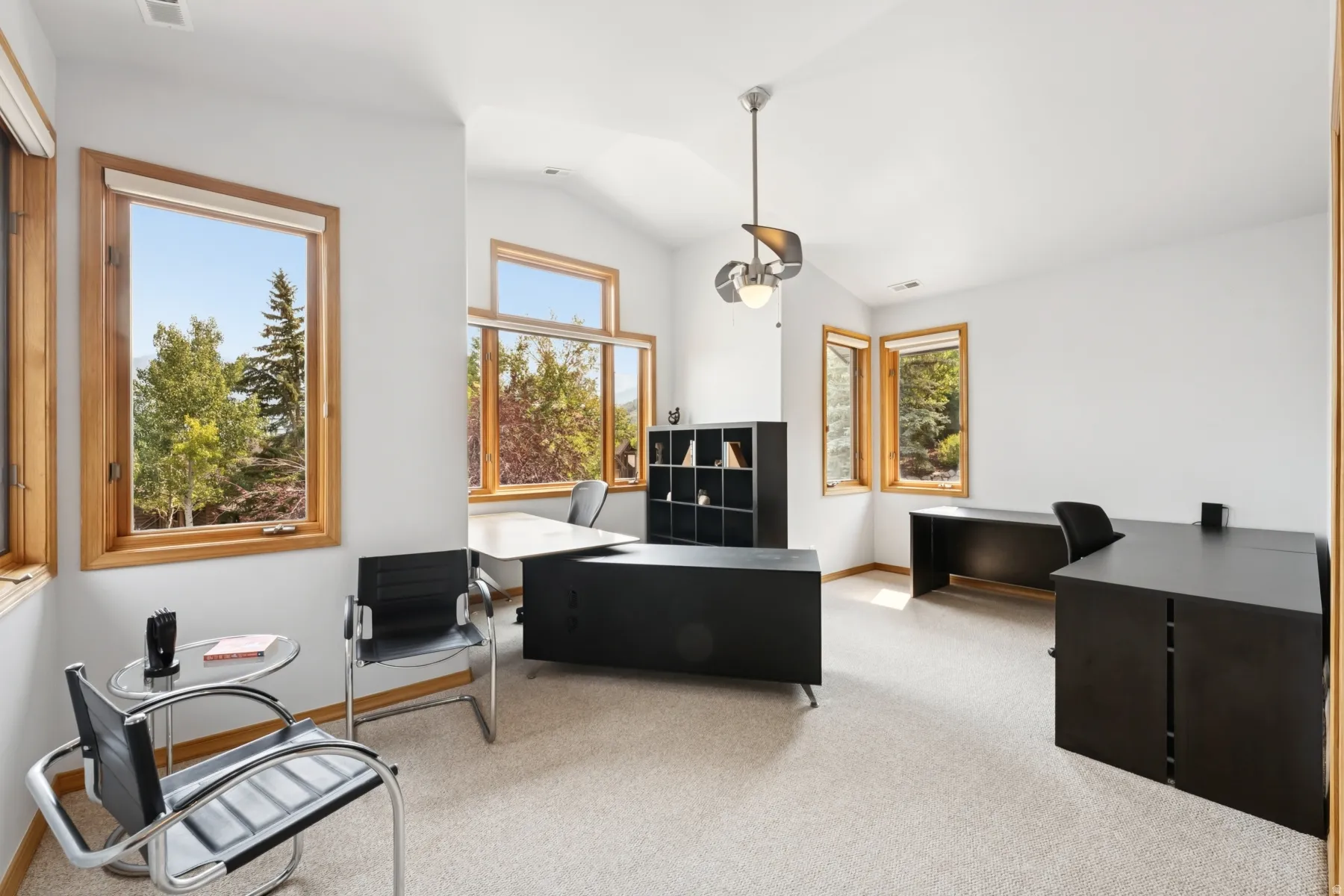 Office area featuring lofted ceiling and light colored carpet