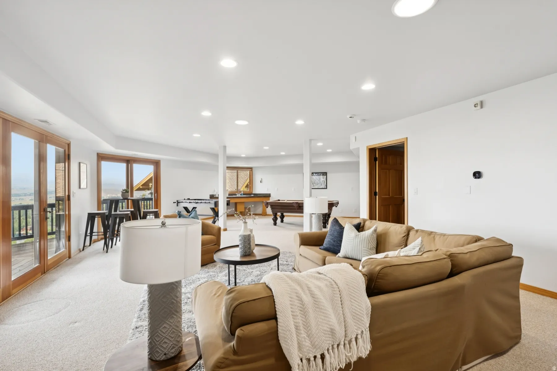 Carpeted living room featuring recessed lighting and billiards