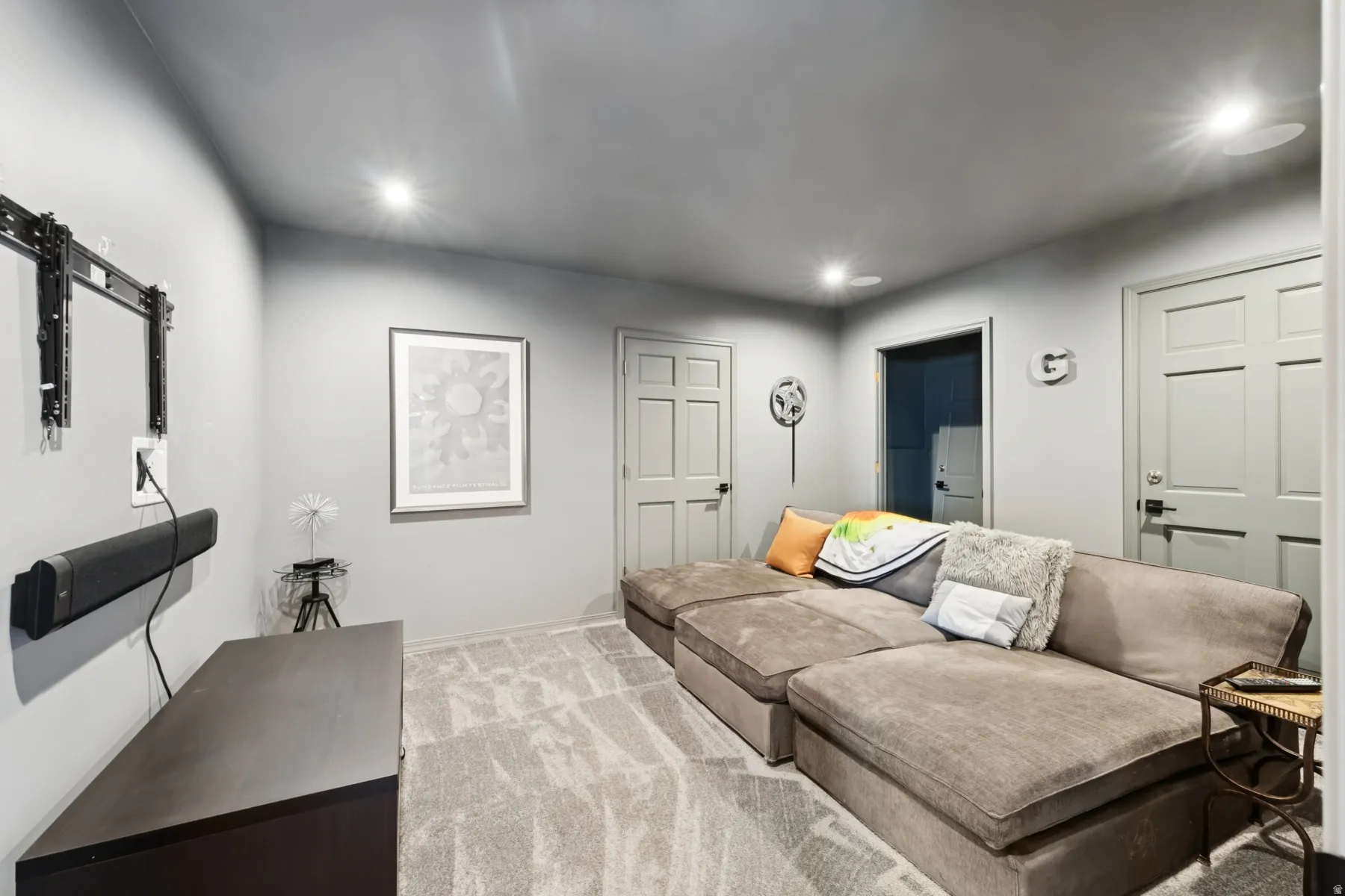 Carpeted living area with recessed lighting