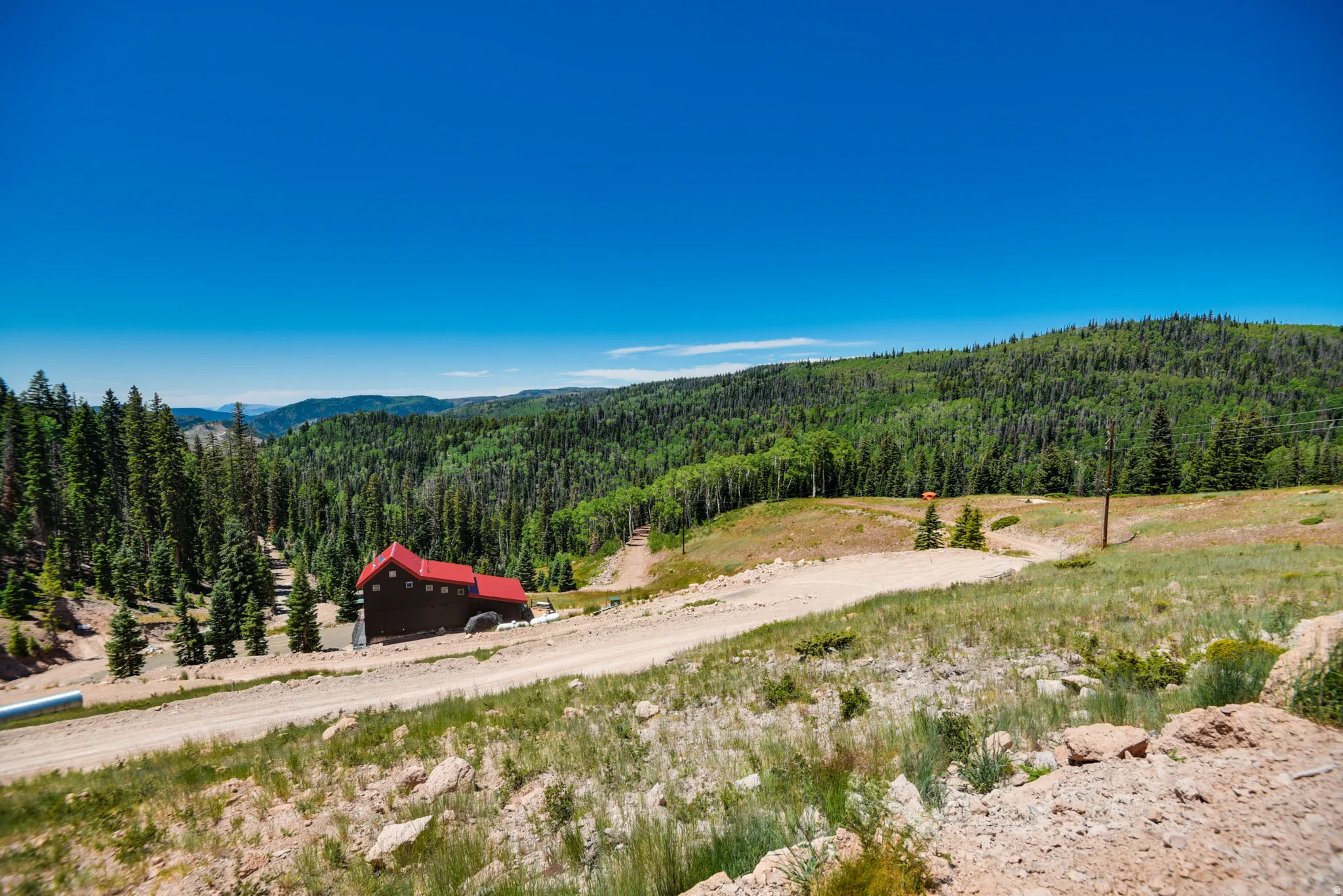 View of mountain background featuring a heavily wooded area and rural landscape