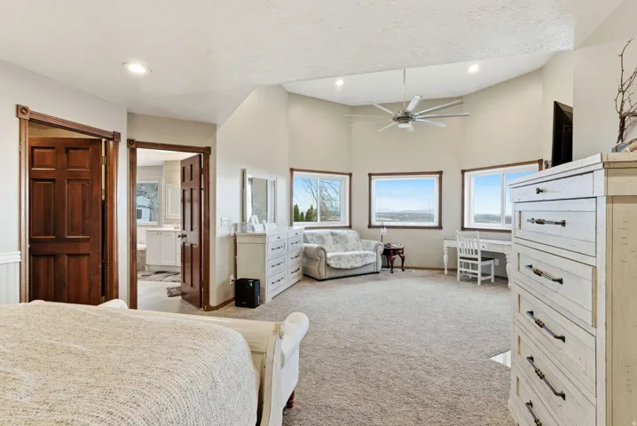 Bedroom featuring ceiling fan, light carpet, high vaulted ceiling, a textured ceiling, and recessed lighting