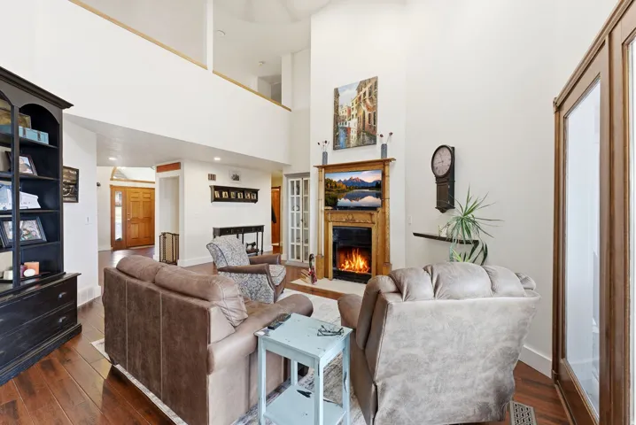 Living area with a fireplace with flush hearth and dark wood-style floors