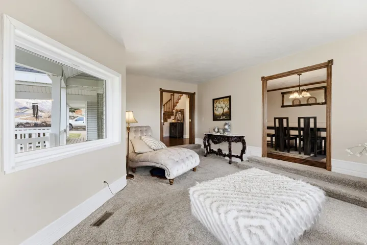 Living area featuring carpet floors and a chandelier