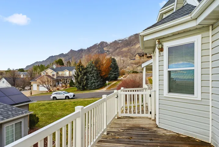 Deck with a mountain view and a residential view