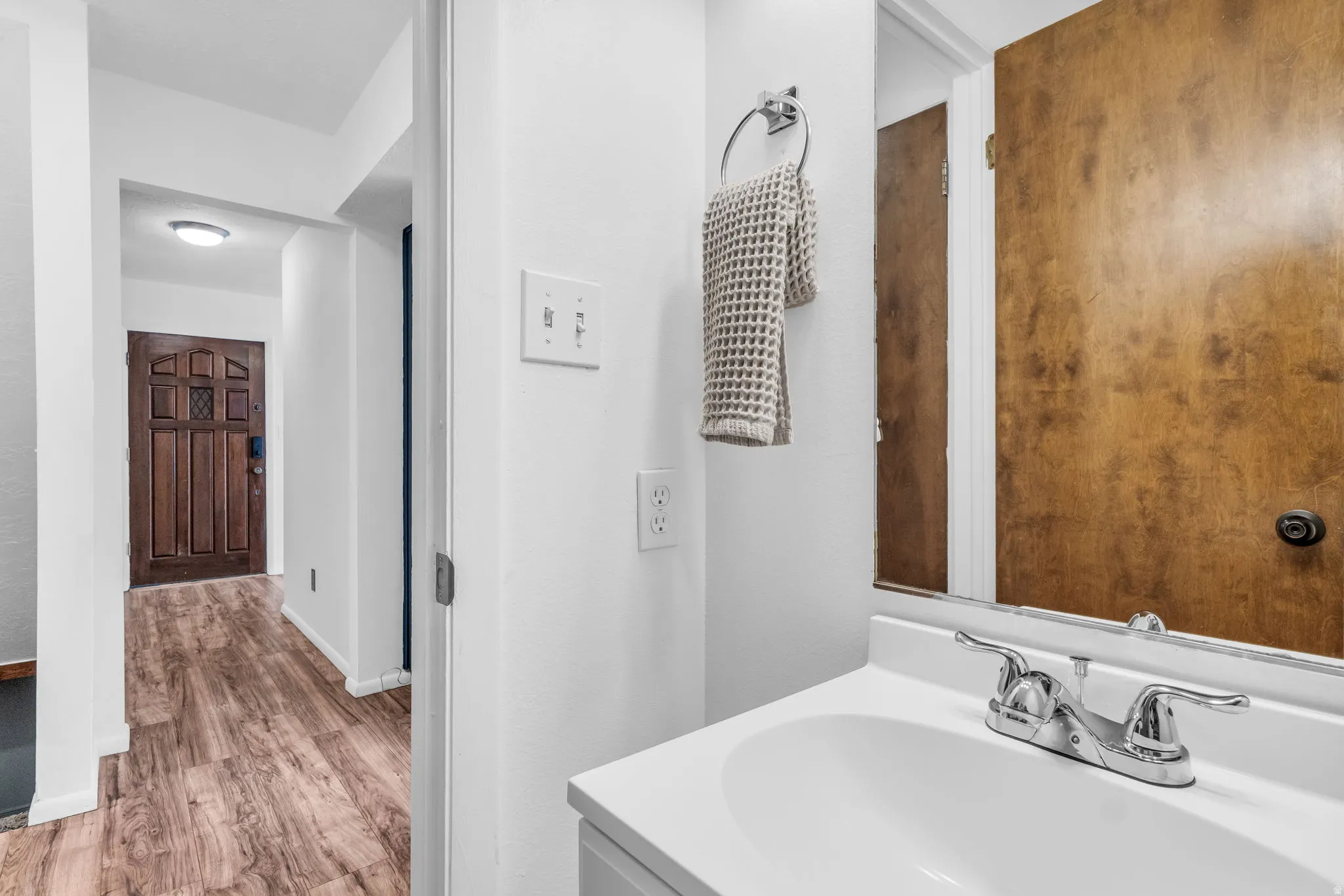 Bathroom with light wood-style flooring and vanity