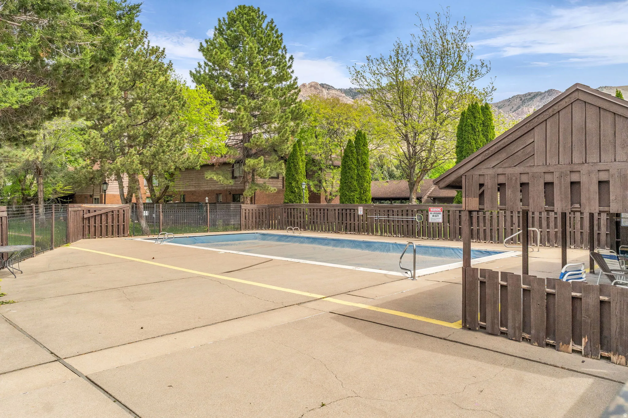 Community pool featuring a patio and a mountain view