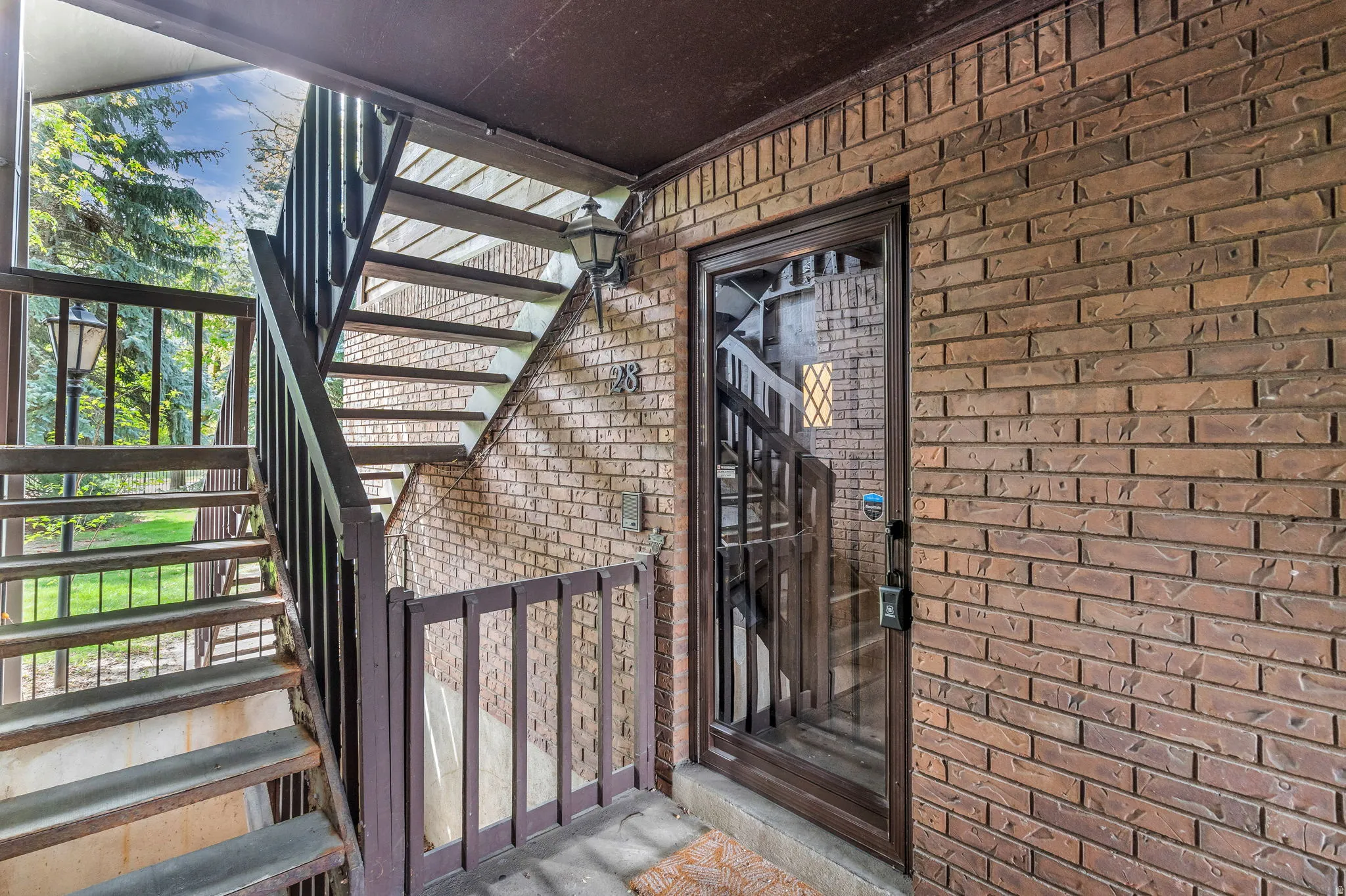 View of exterior entry with brick siding