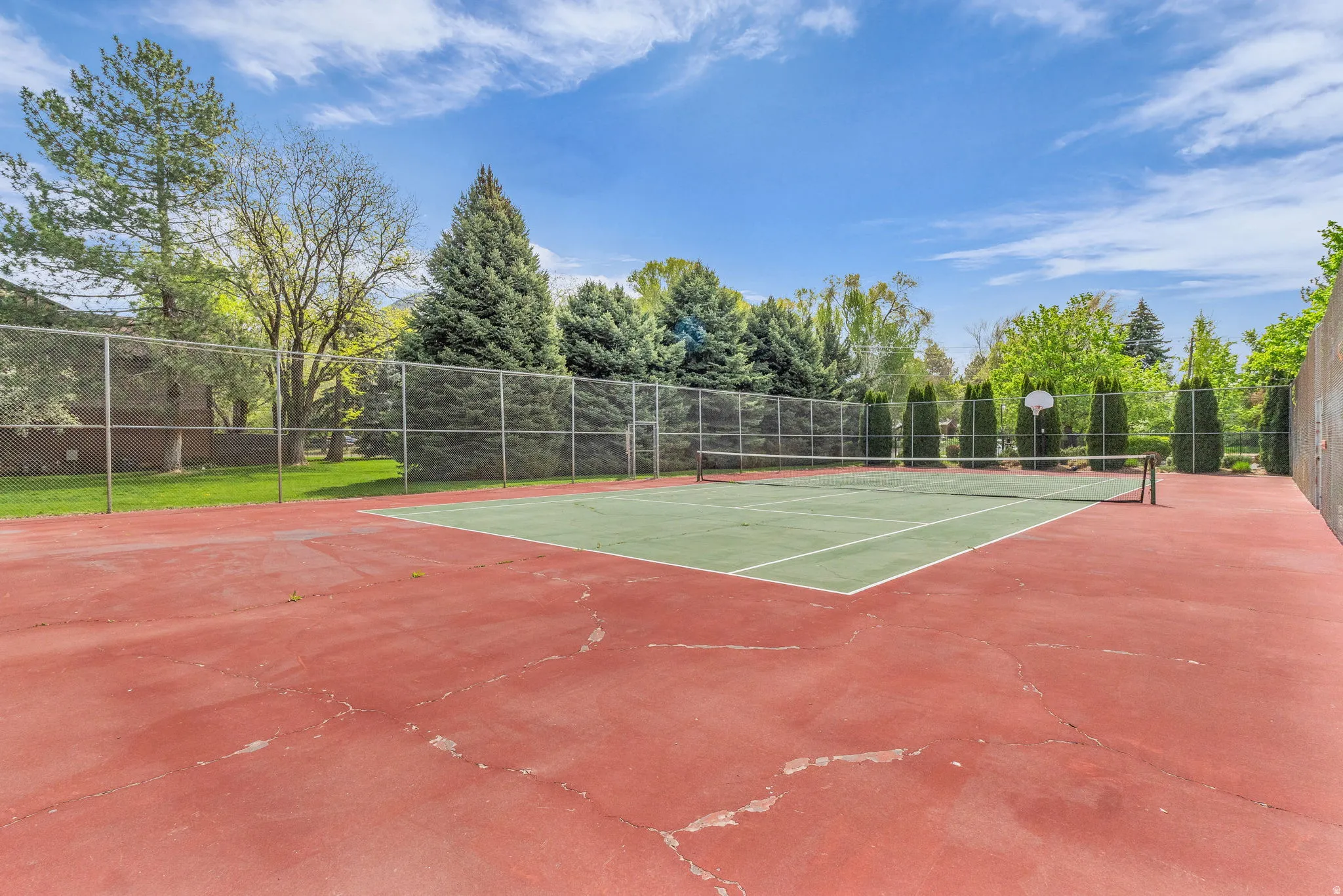 View of tennis court with community basketball court