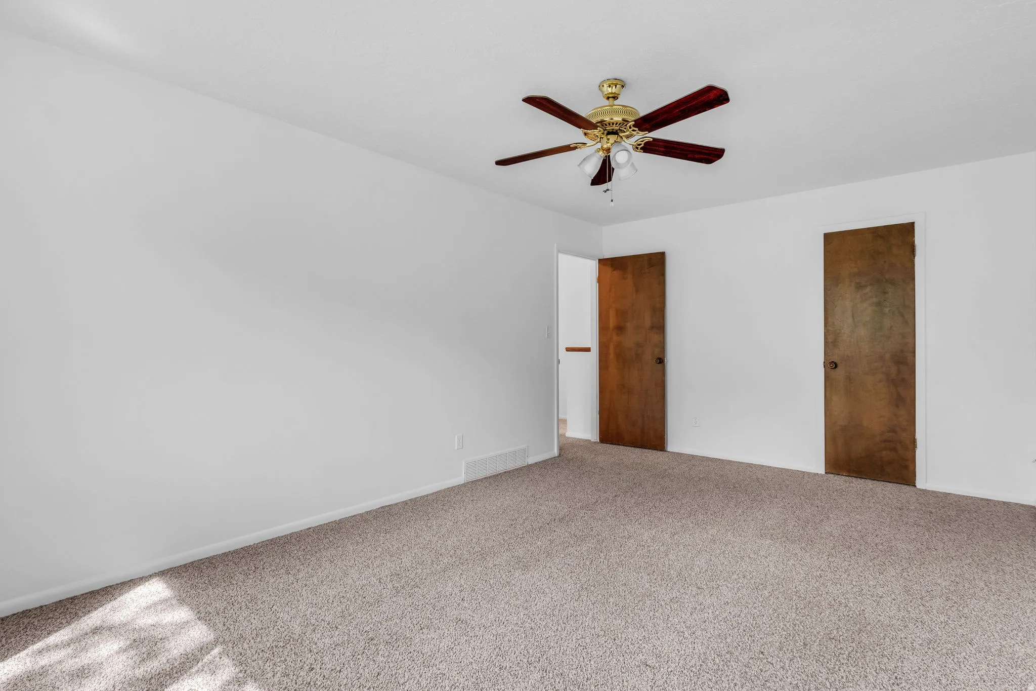 Unfurnished bedroom with carpet floors and a ceiling fan