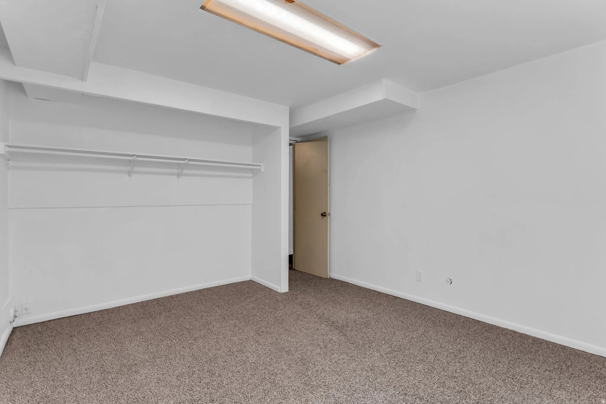 Unfurnished bedroom featuring carpet flooring and a closet