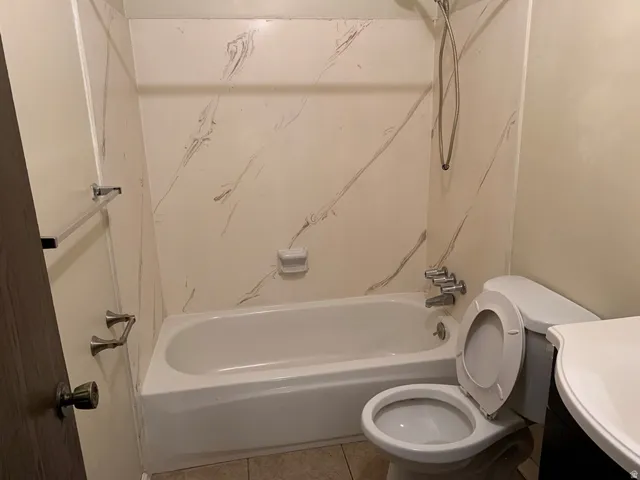 Full bathroom with vanity, tub / shower combination, and tile patterned floors