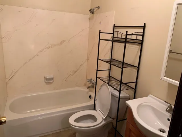 Bathroom with vanity, shower / washtub combination, and tile patterned flooring