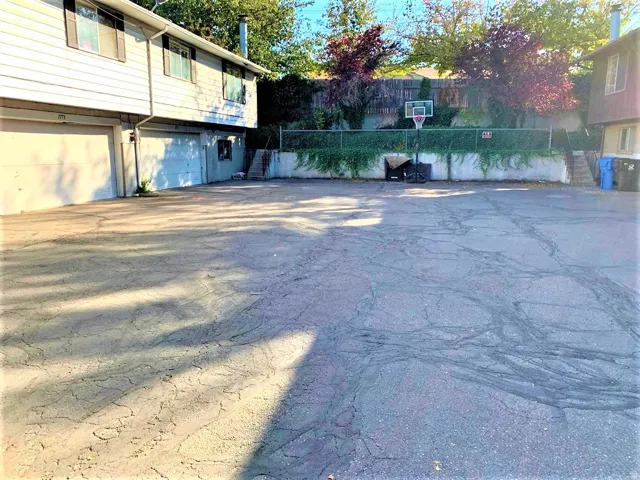 View of yard with driveway and a garage