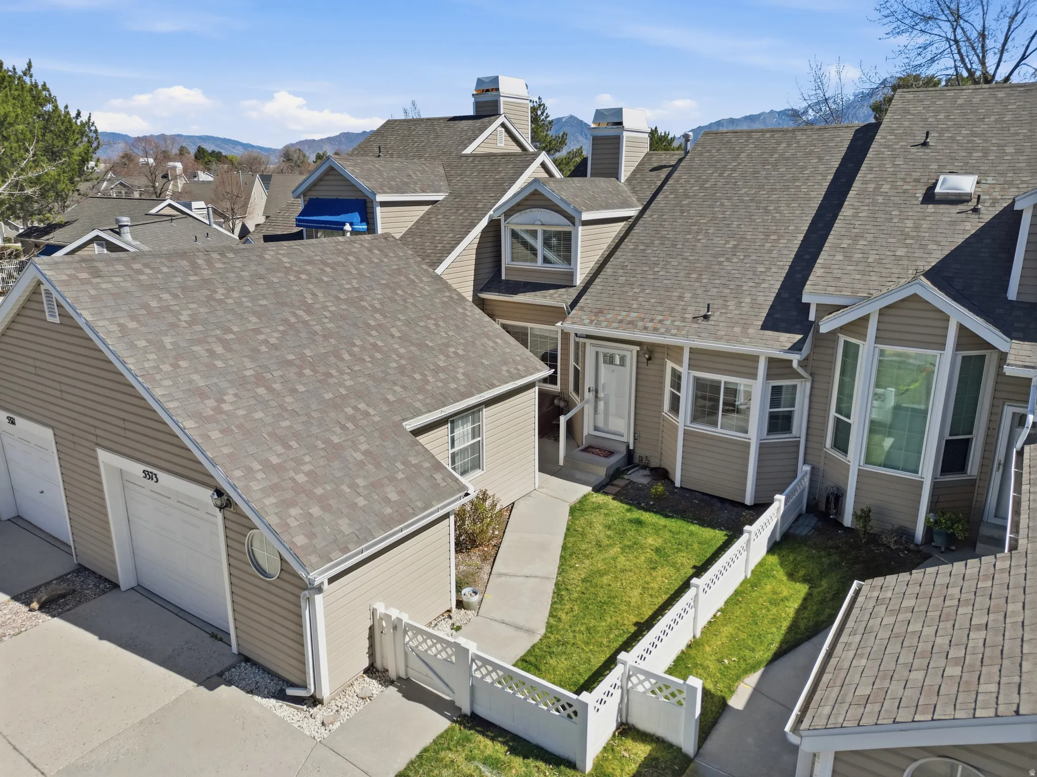 Aerial perspective of suburban area with a mountainous background