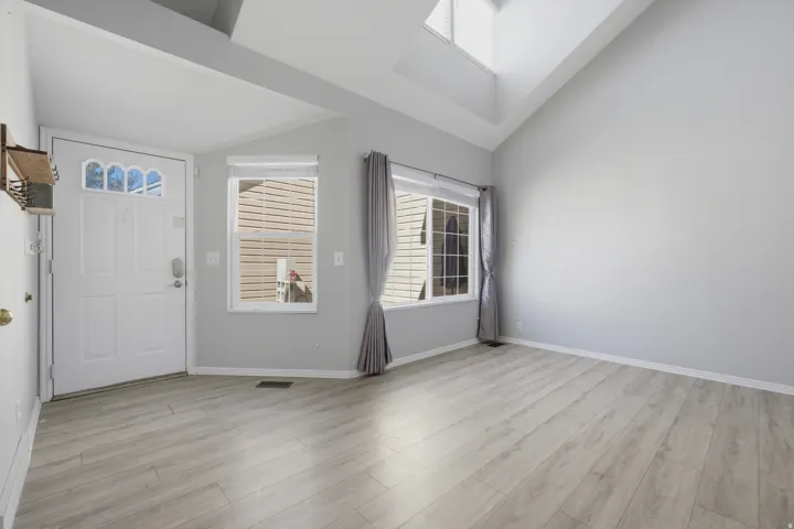 Entrance foyer featuring light wood-style floors and lofted ceiling