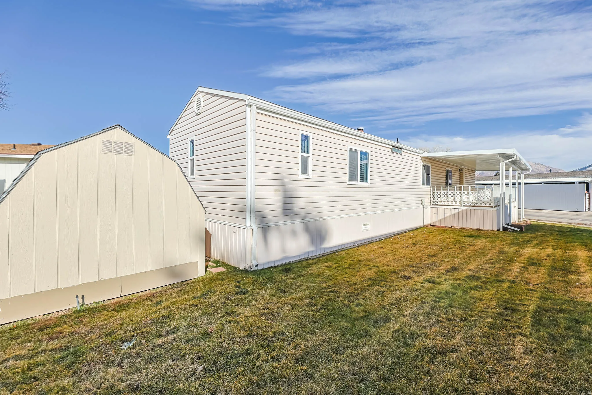 View of property exterior with a yard