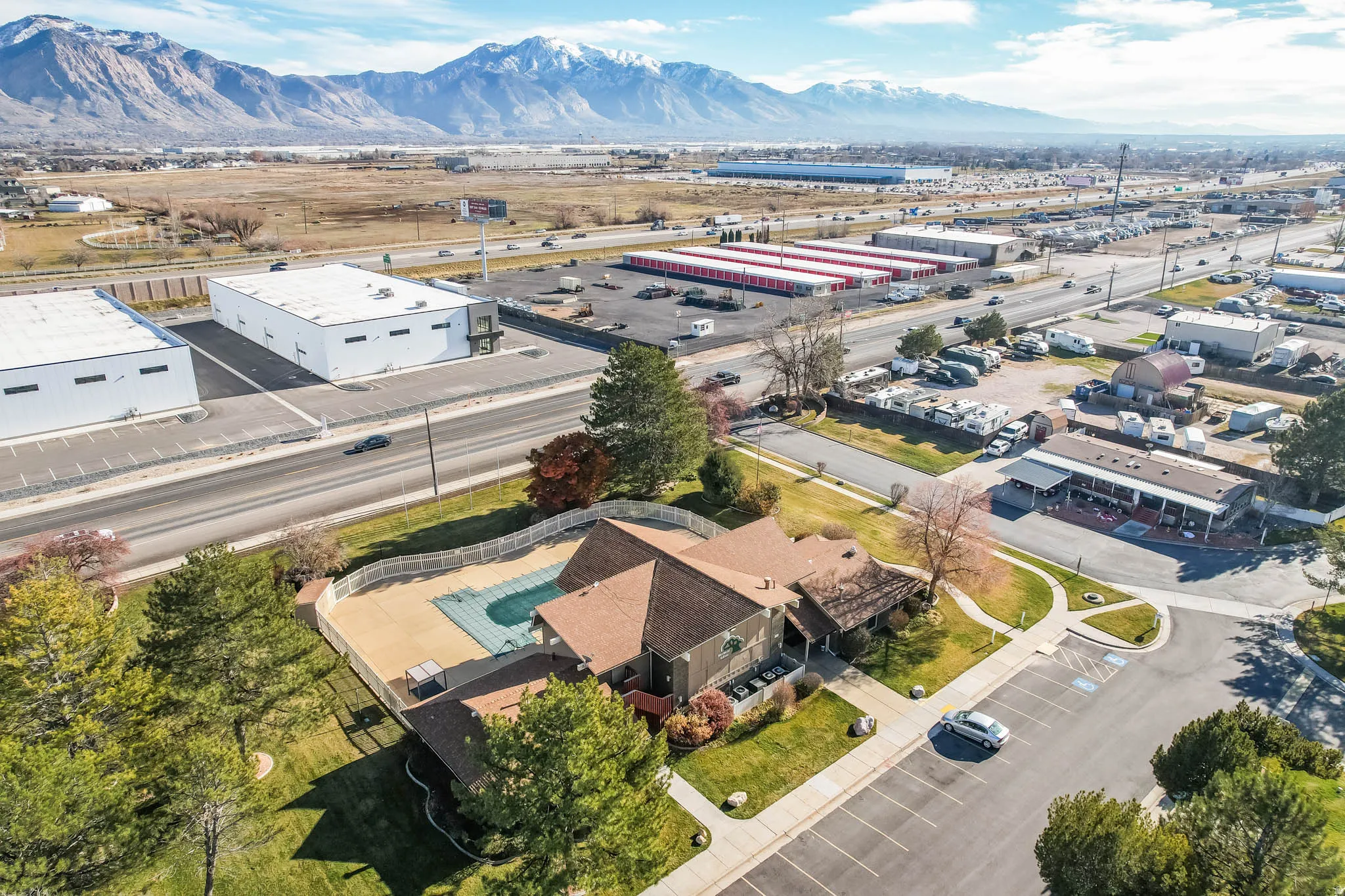 Drone / aerial view of industrial structures and a mountainous background