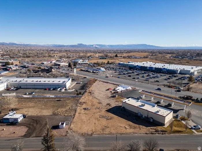 Drone / aerial view of industrial structures and a mountain backdrop