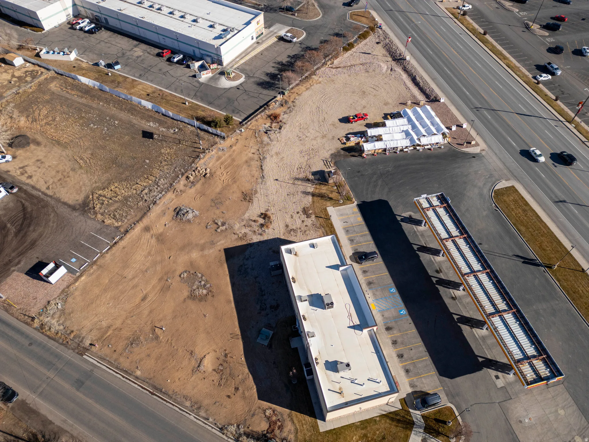 Aerial view of property and surrounding area featuring an industrial area