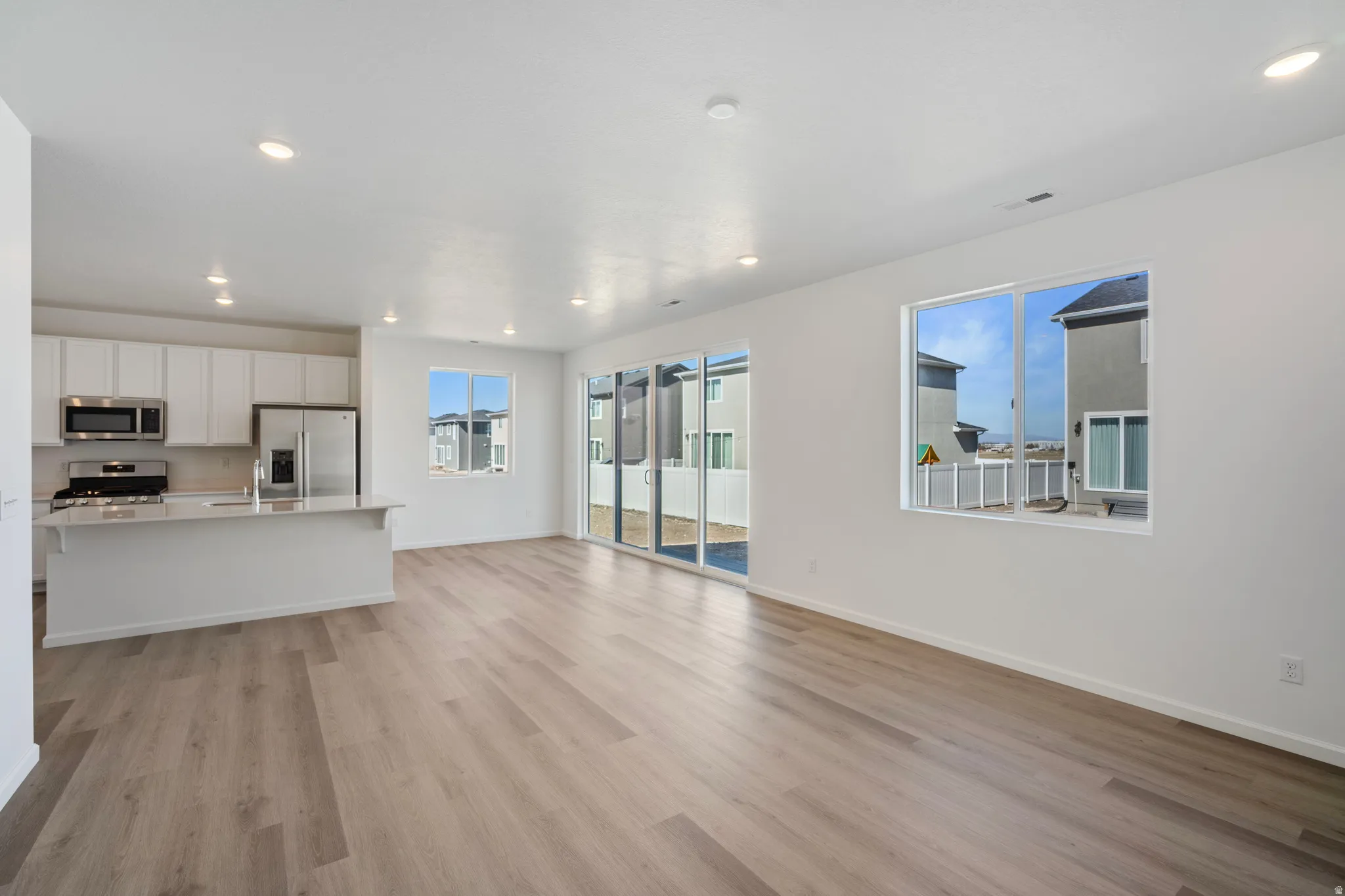 Unfurnished living room featuring light wood-type flooring and recessed lighting
