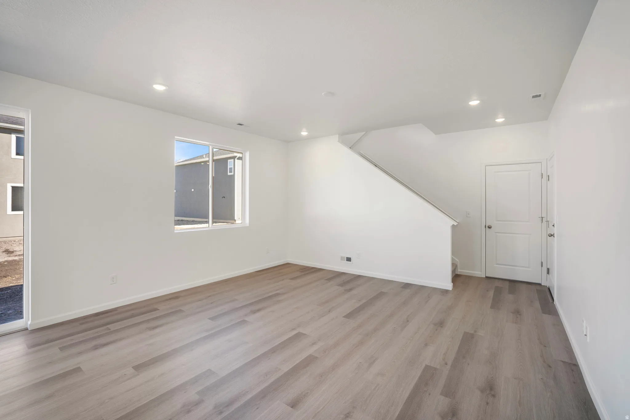 Unfurnished living room featuring light wood-style flooring and recessed lighting