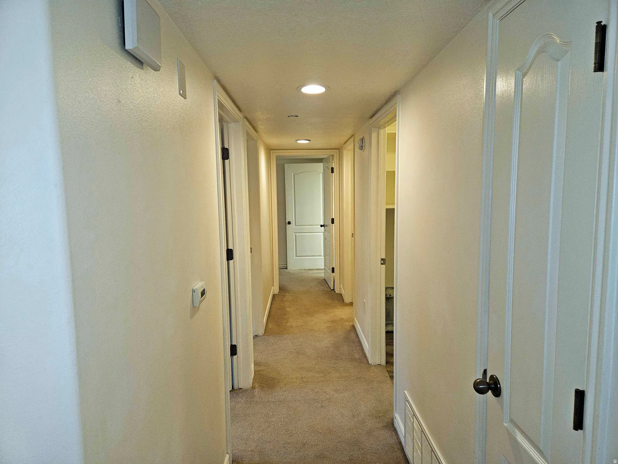 Corridor featuring carpet floors and recessed lighting