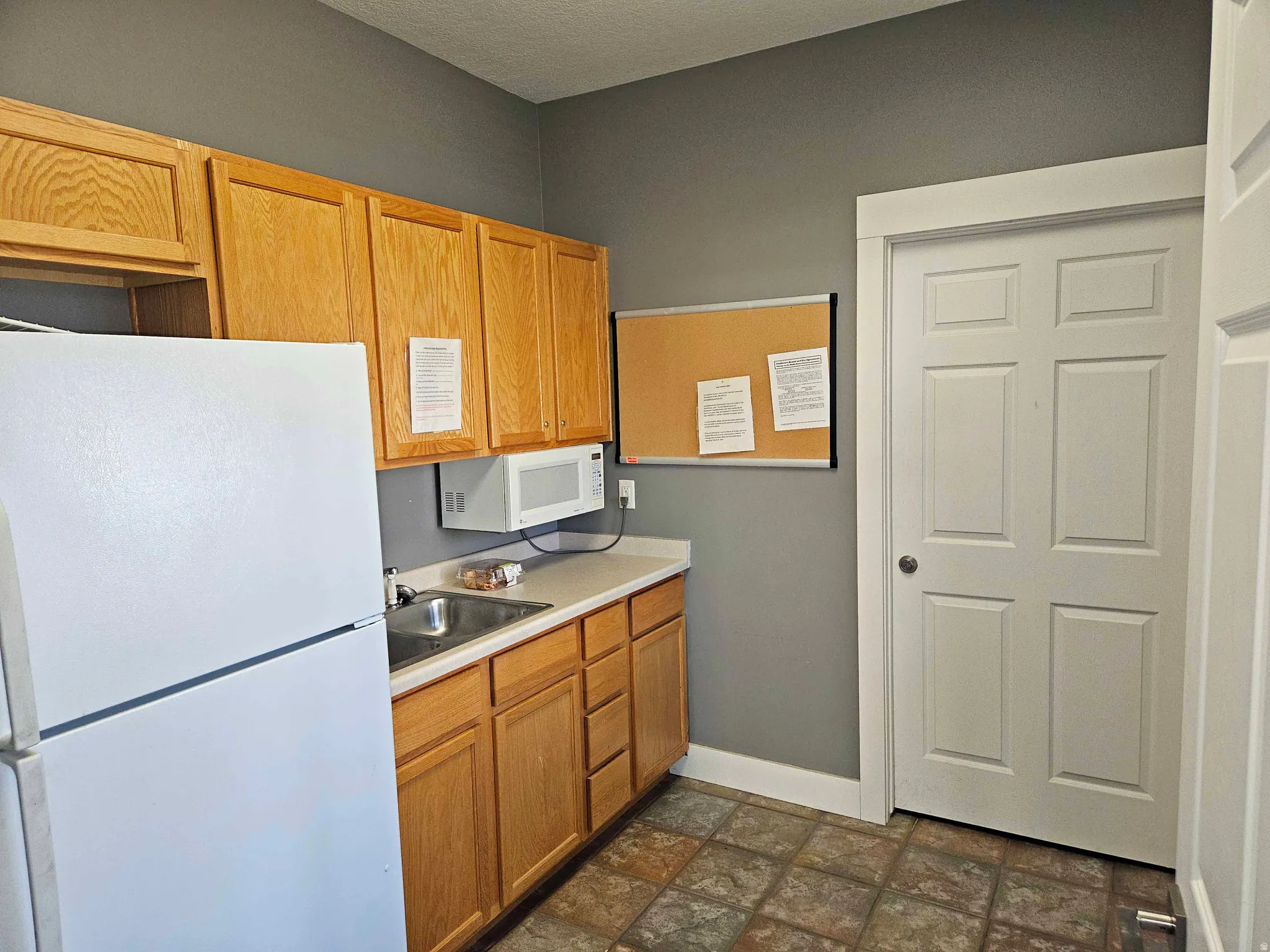 Kitchen featuring white appliances and light countertops