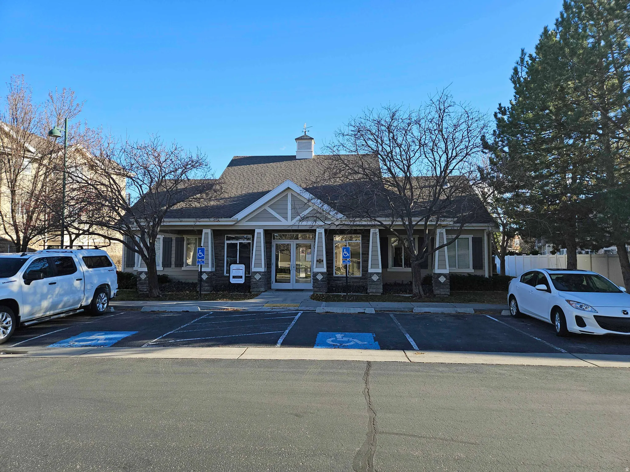 View of building exterior with uncovered parking