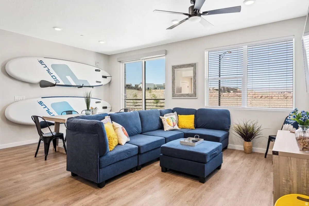 Living area featuring light wood-type flooring, ceiling fan, and recessed lighting