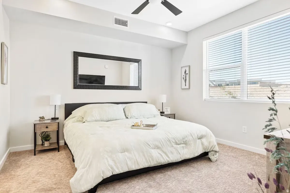 Bedroom with light carpet and ceiling fan