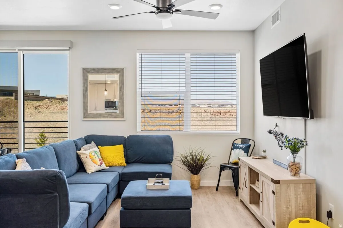Living room with wood finished floors and a ceiling fan