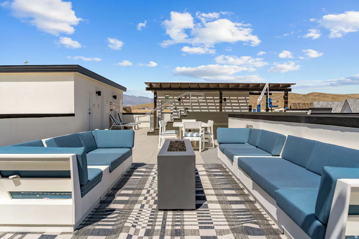 View of patio featuring an outdoor living space with a fire pit and a mountain view