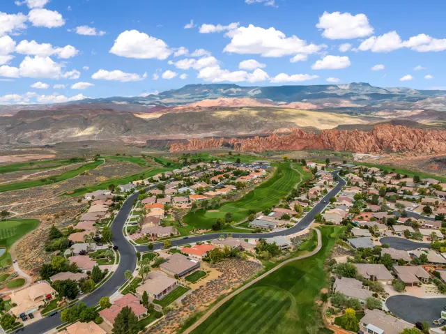 View of property location featuring mountains and nearby suburban area