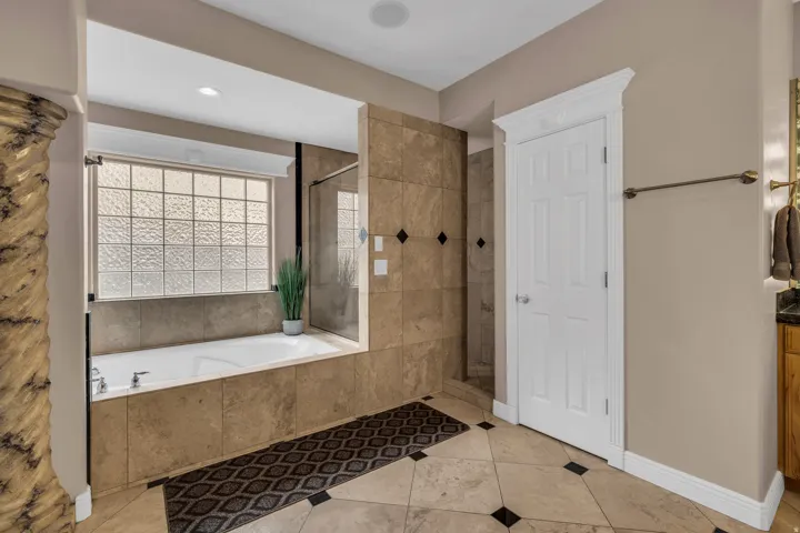 Bathroom with a garden tub, tile patterned floors, tiled shower, and recessed lighting