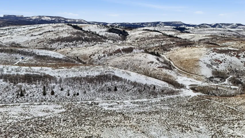 Snowy aerial view featuring a mountain view