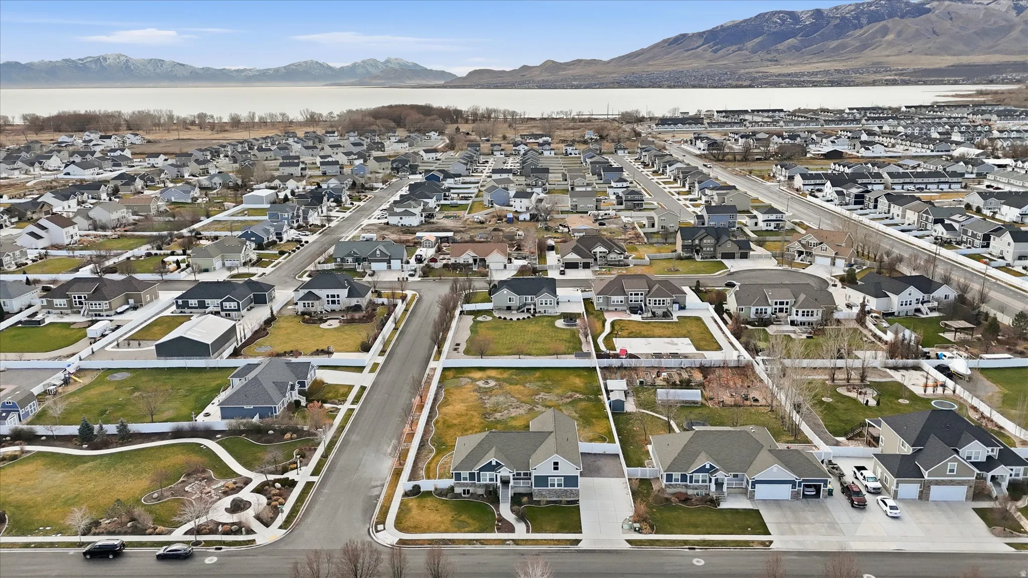 Aerial view of residential area featuring a mountain backdrop and Utah Lake