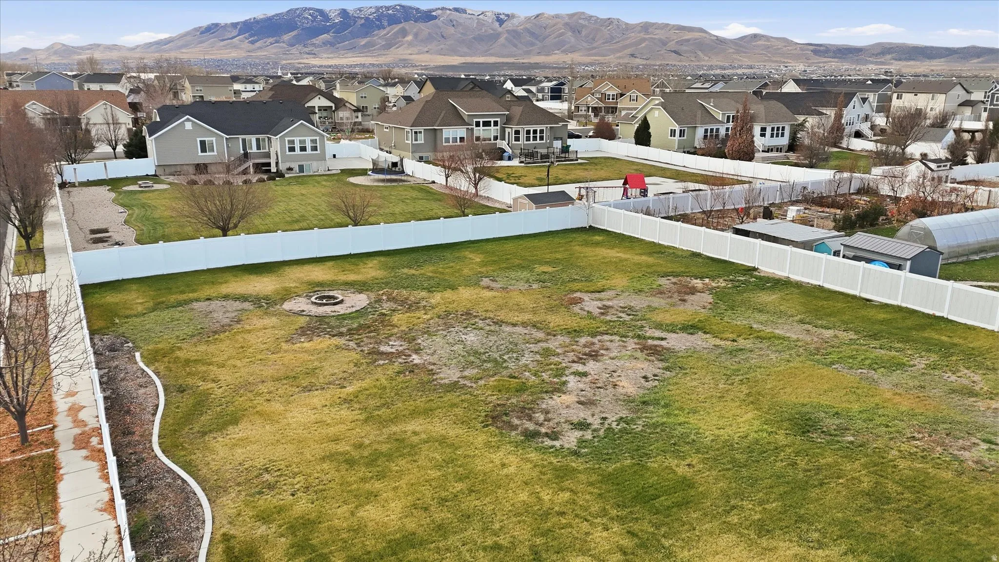 Aerial view of residential area featuring a mountainous background