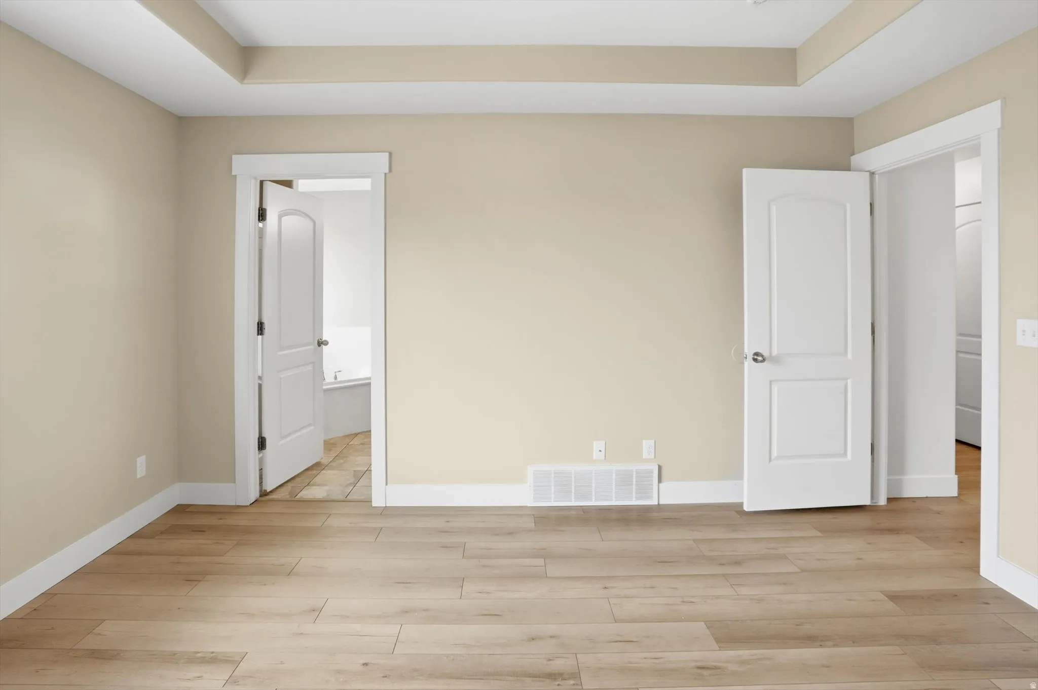 Primary Bedroom with ensuite bath, and a tray ceiling