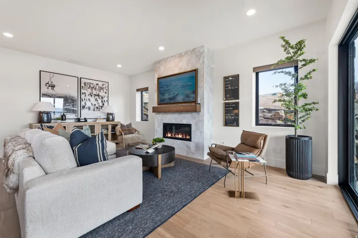 Living area with light wood-style flooring, a fireplace, and recessed lighting