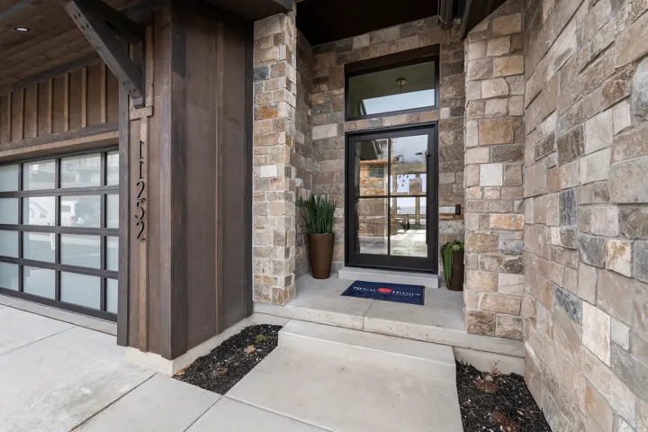 View of exterior entry with stone siding