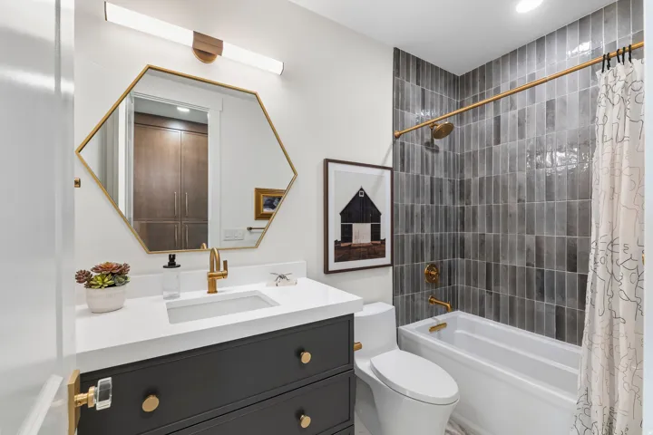 Full bathroom with shower / bath combo with shower curtain and vanity
