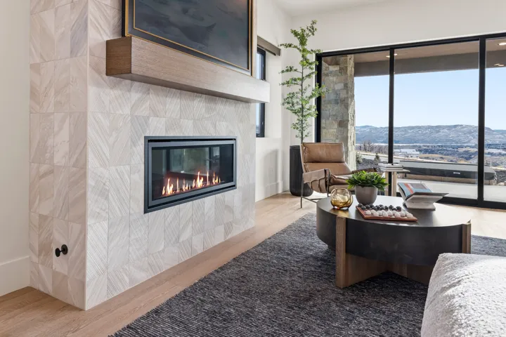 Living room featuring wood finished floors, a tile fireplace, and a mountain view