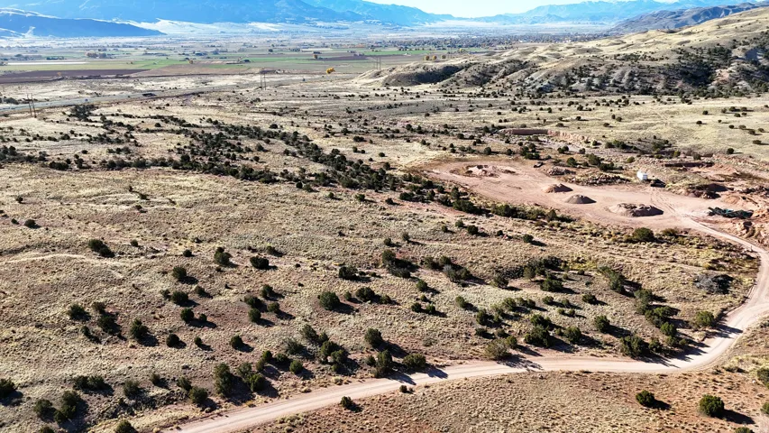 Expansive land parcel featuring natural desert flora, distant mountain ranges, and open terrain
